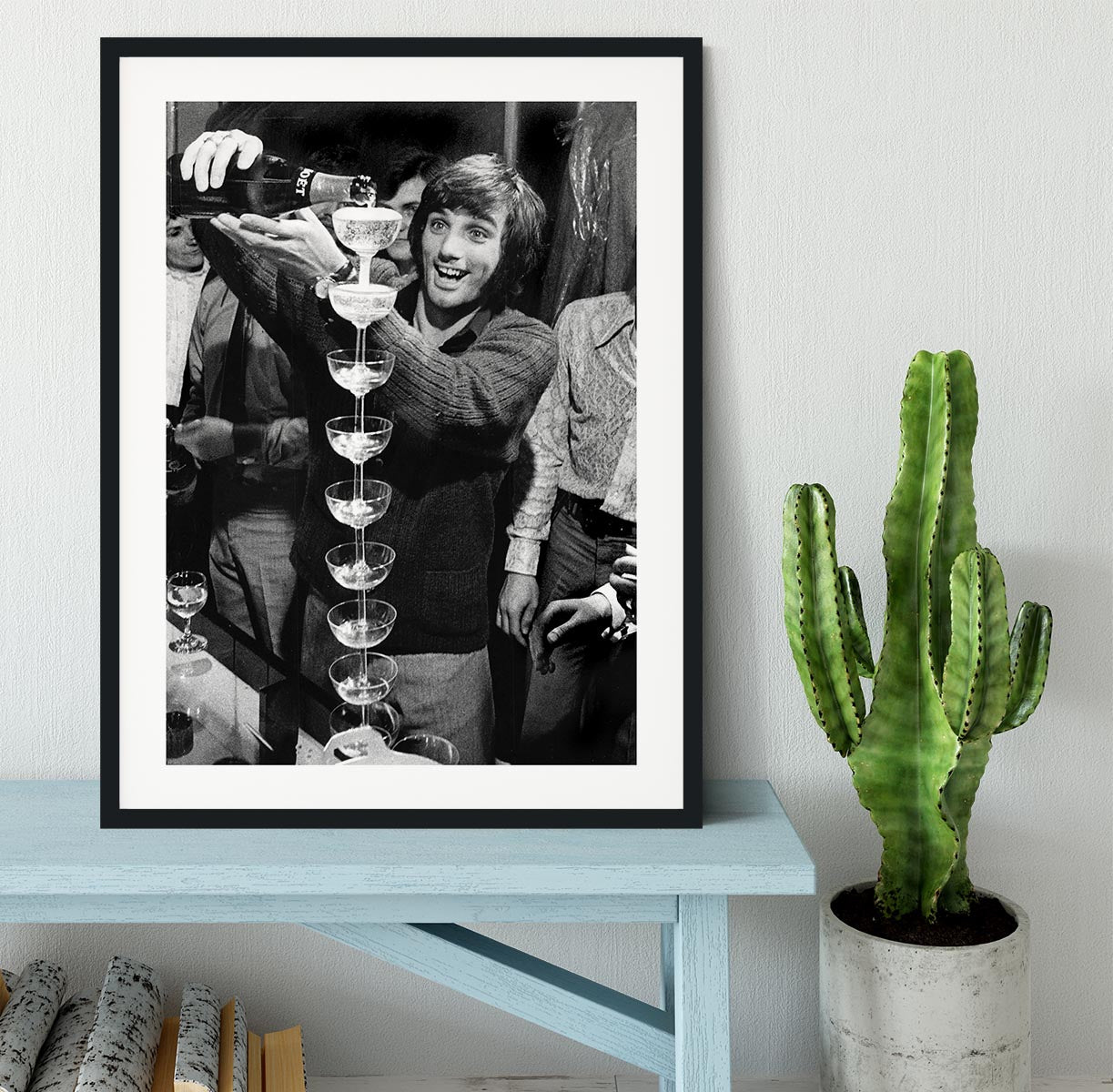 George Best pouring champagne Framed Print - Canvas Art Rocks - 1