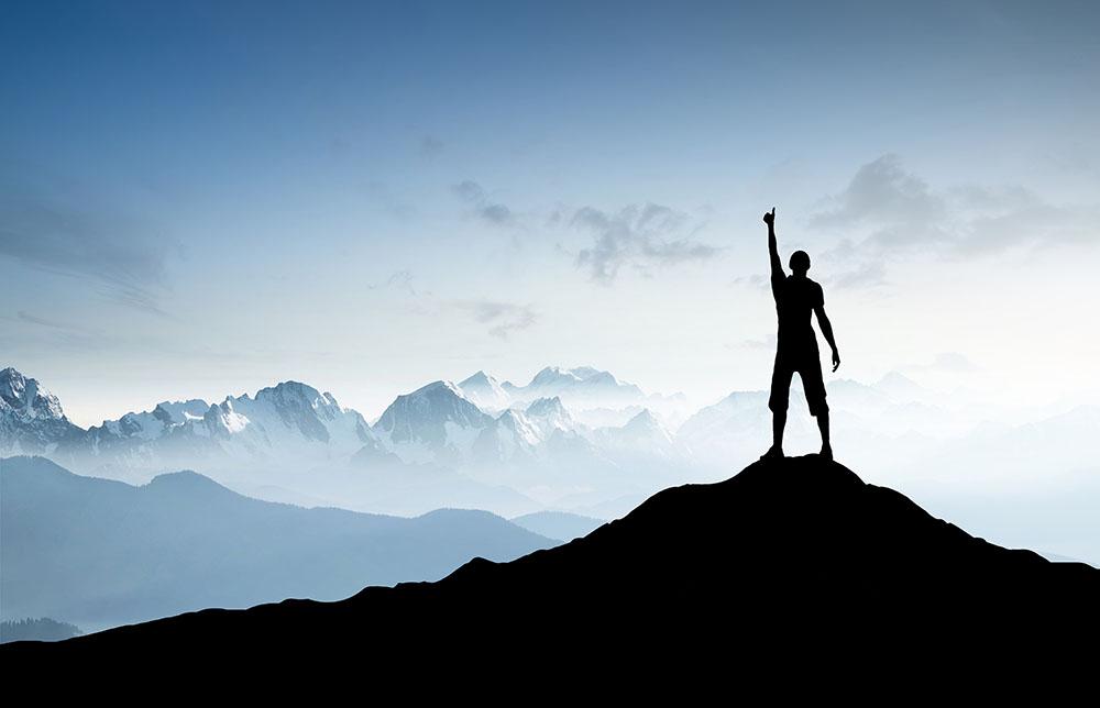 Winner silhouette on the mountain top Wall Mural Wallpaper - Canvas Art Rocks - 1