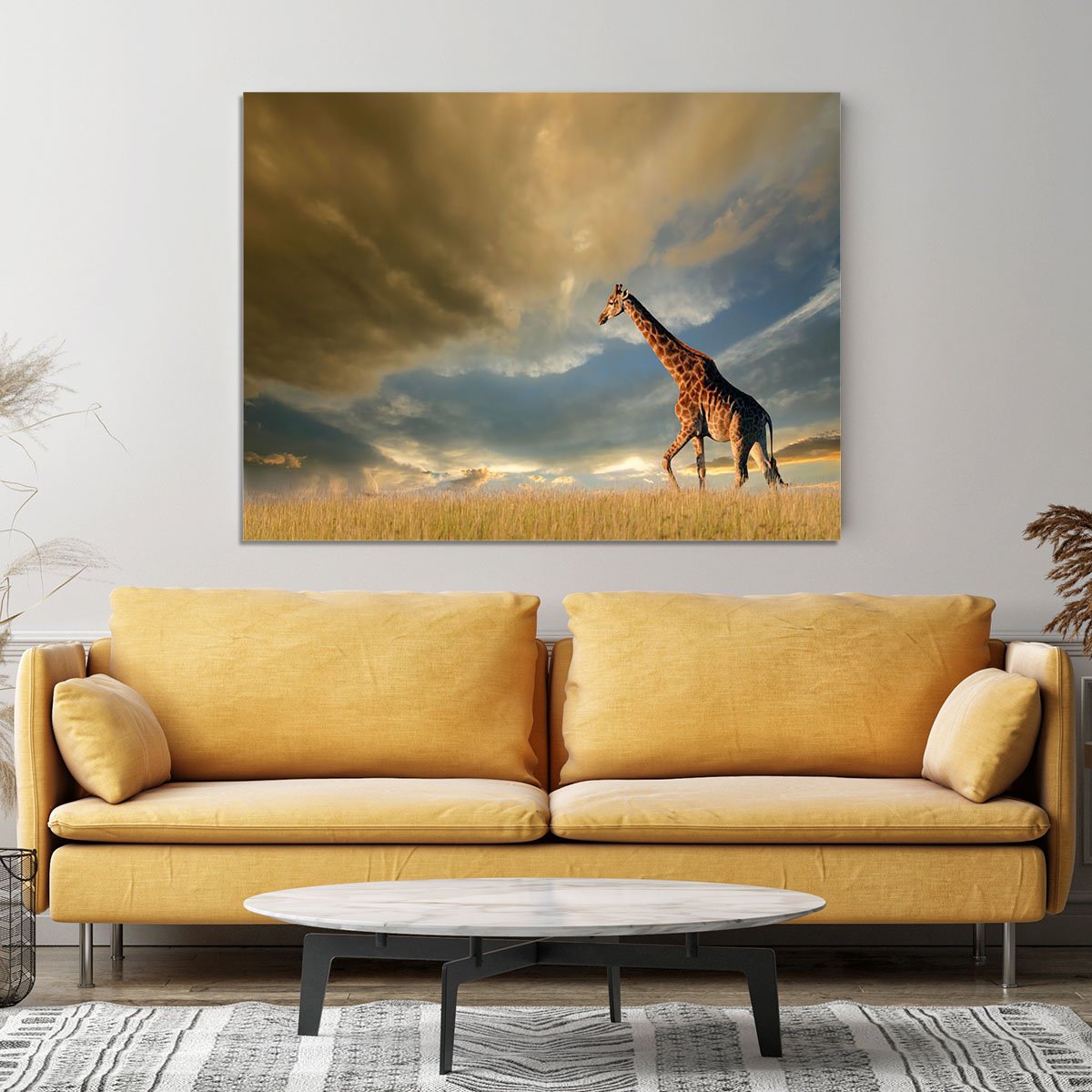 A giraffe walking on the African plains against a dramatic sky Canvas Print or Poster