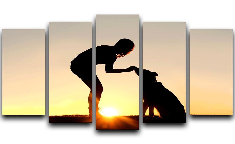 A silhouette of a girl sitting outside in the grass with her pet German Shepherd Mix Dog feeding him treats during training in front of a sunsetting sky. 5 Split Panel Canvas - Canvas Art Rocks - 1