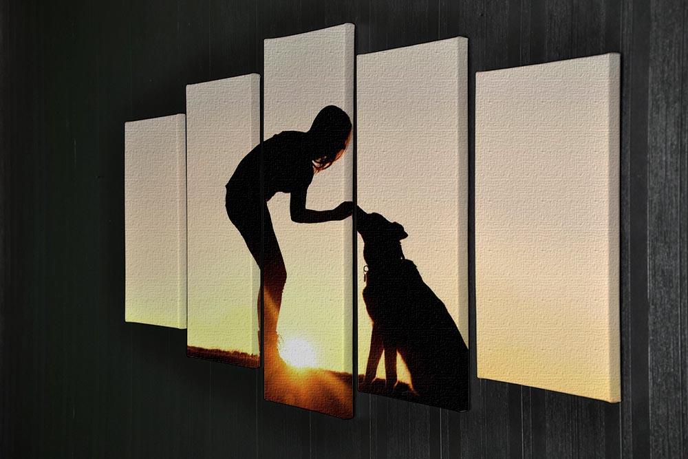 A silhouette of a girl sitting outside in the grass with her pet German Shepherd Mix Dog feeding him treats during training in front of a sunsetting sky. 5 Split Panel Canvas - Canvas Art Rocks - 2