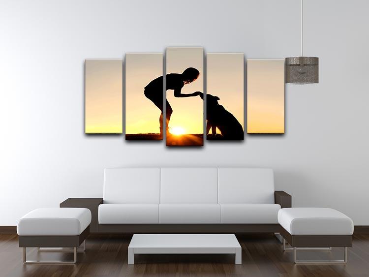 A silhouette of a girl sitting outside in the grass with her pet German Shepherd Mix Dog feeding him treats during training in front of a sunsetting sky. 5 Split Panel Canvas - Canvas Art Rocks - 3