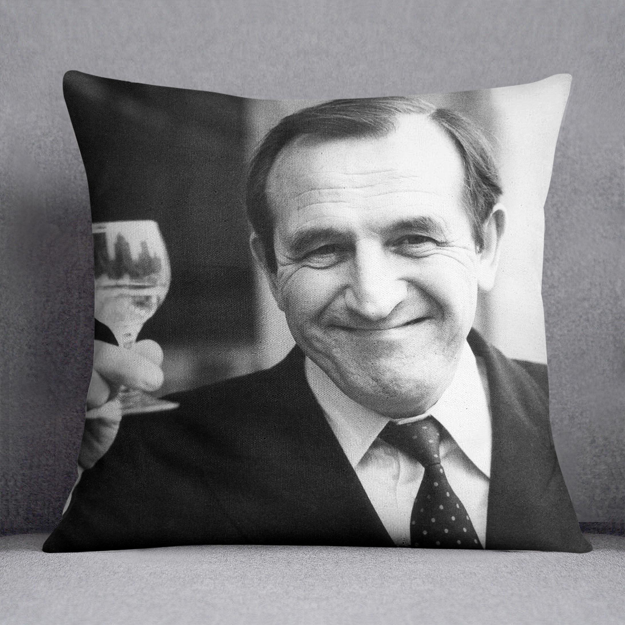 Actor Leonard Rossiter raises a glass Cushion