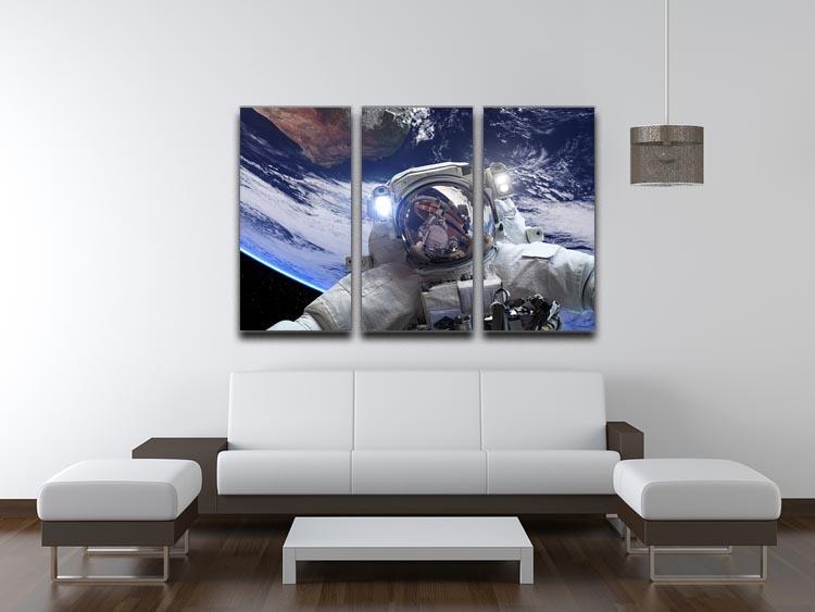 Astronaut in outer space against the backdrop 3 Split Panel Canvas Print - Canvas Art Rocks - 3