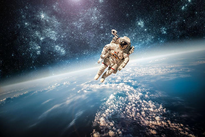 Astronaut in outer space planet earth Wall Mural Wallpaper