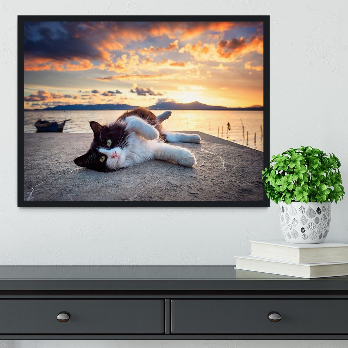 Black and white cat lying under a dramatic sunset on the lagoon Framed Print - Canvas Art Rocks - 2