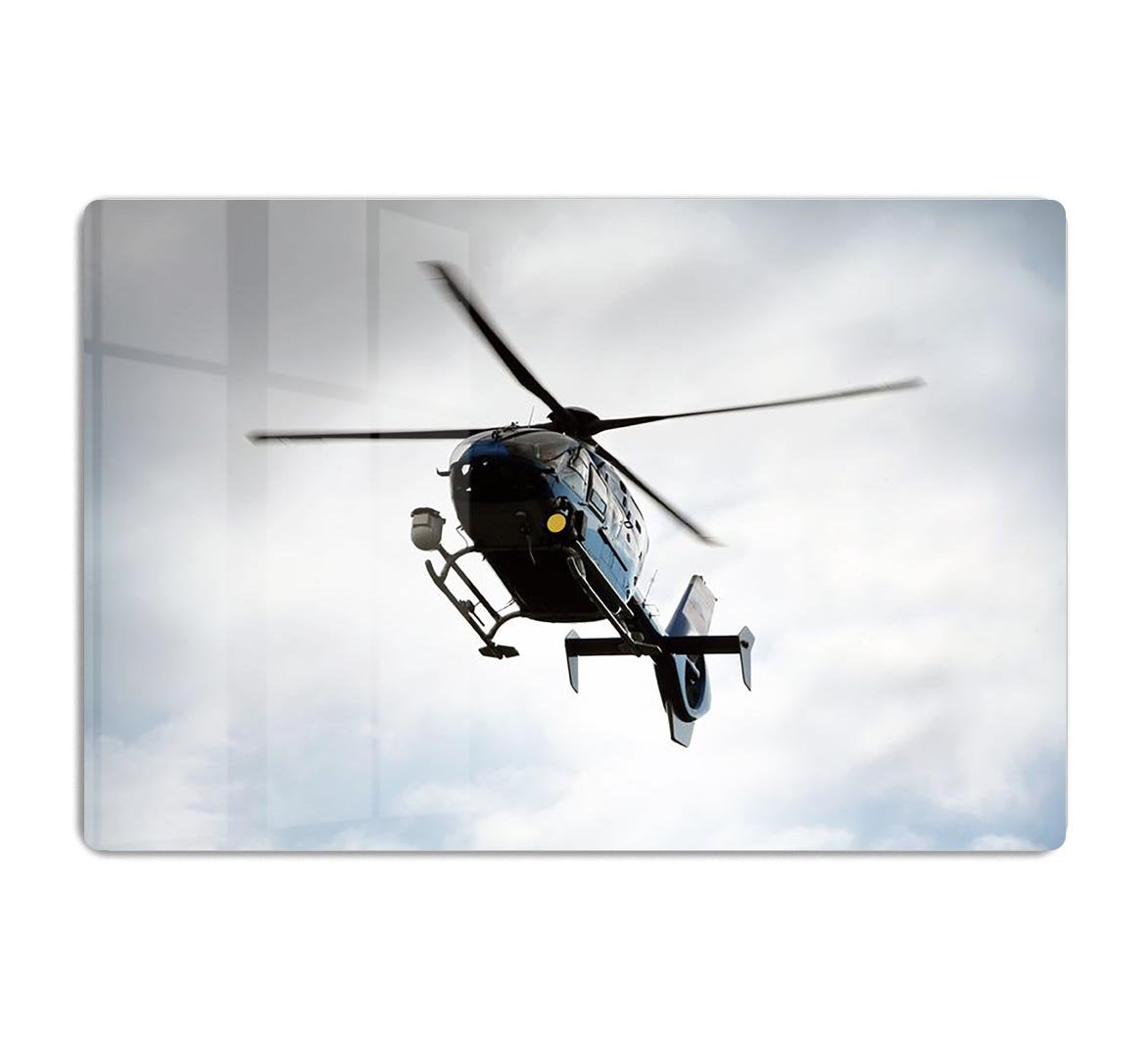 Blue and silver police helicopter flying above HD Metal Print
