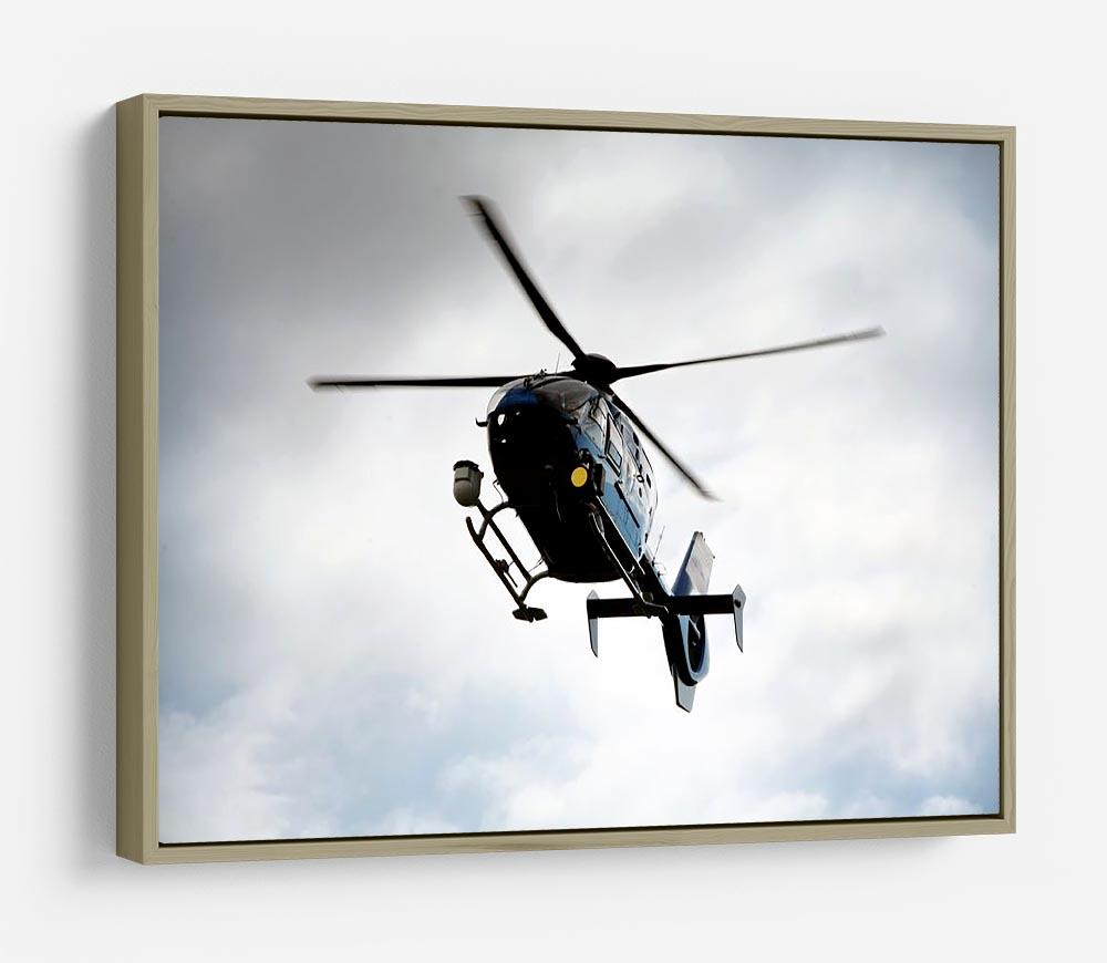 Blue and silver police helicopter flying above HD Metal Print