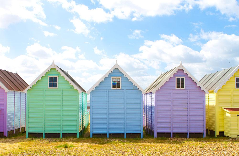 British beach huts on a bright sunny day Wall Mural Wallpaper - Canvas Art Rocks - 1