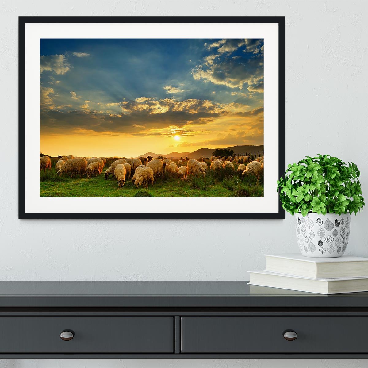 Flock of sheep grazing in a hill at sunset Framed Print - Canvas Art Rocks - 1