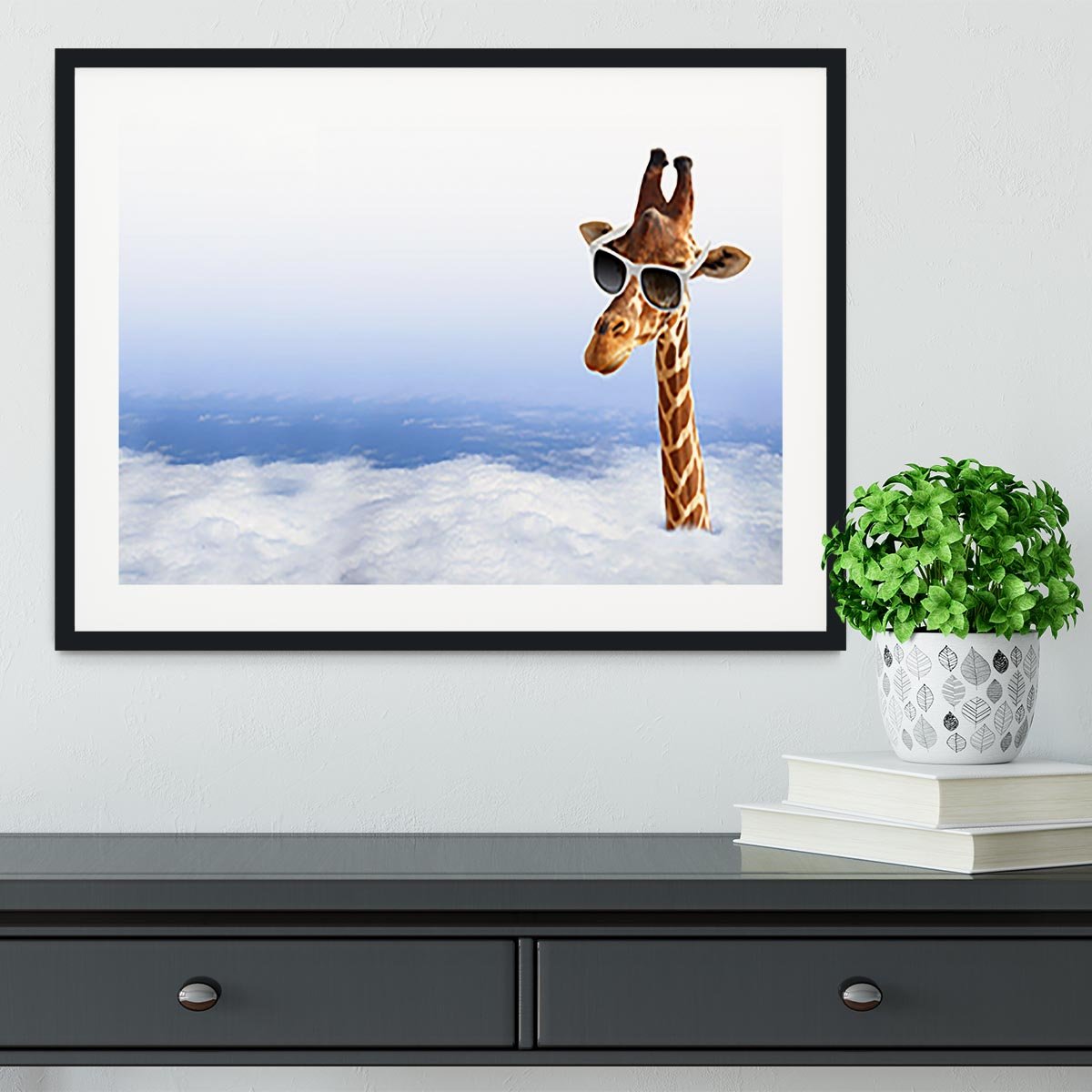 Funny giraffe with sunglasses coming out of the clouds Framed Print - Canvas Art Rocks - 1