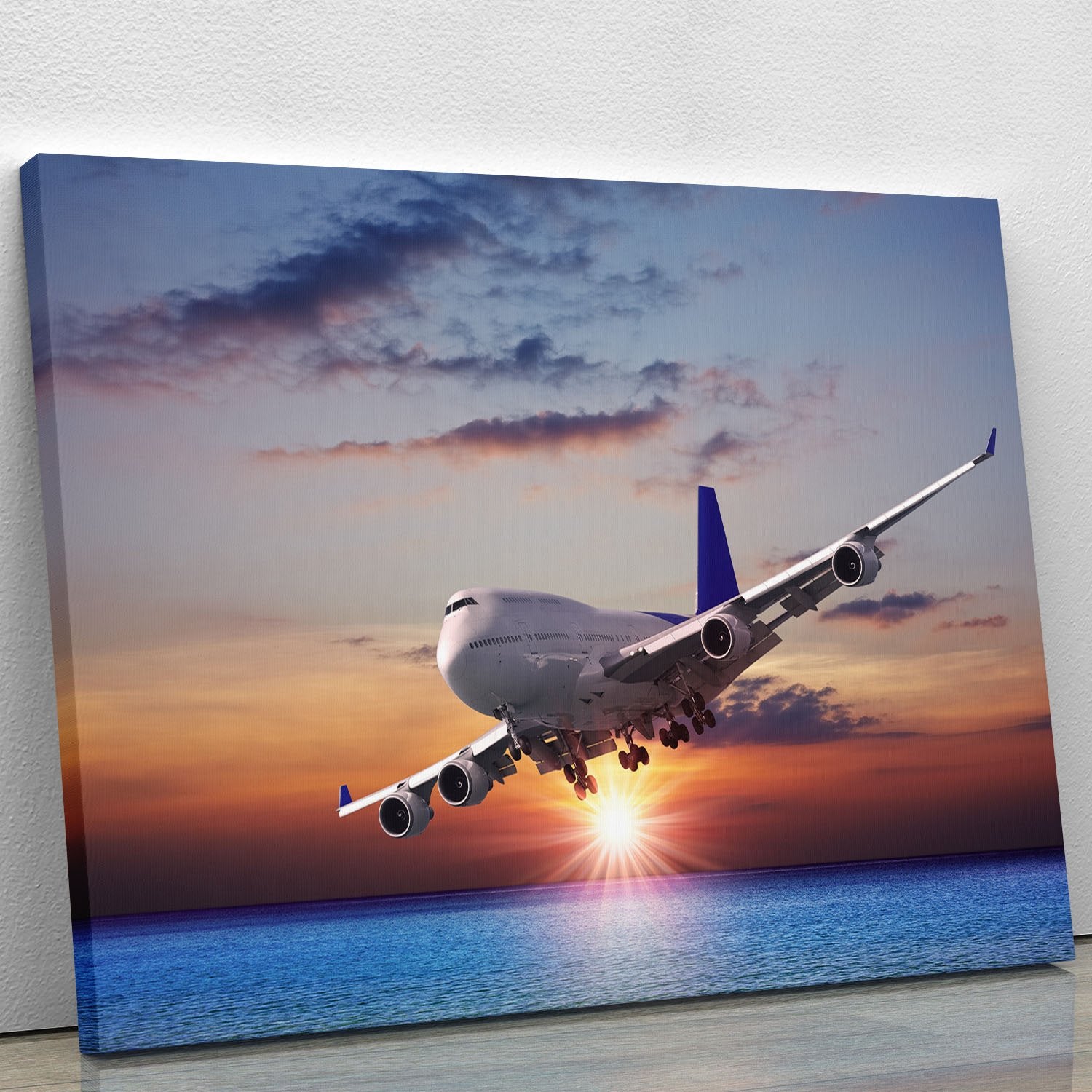 Jet liner over the sea at dusk Canvas Print or Poster