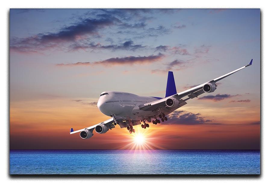 Jet liner over the sea at dusk Canvas Print or Poster  - Canvas Art Rocks - 1