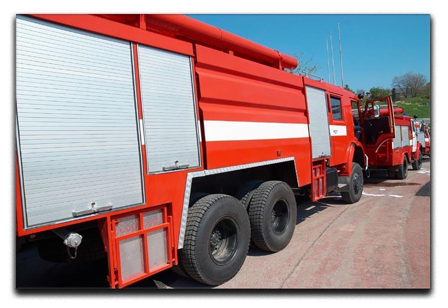 Red fire engine standing on the road Canvas Print or Poster  - Canvas Art Rocks - 1