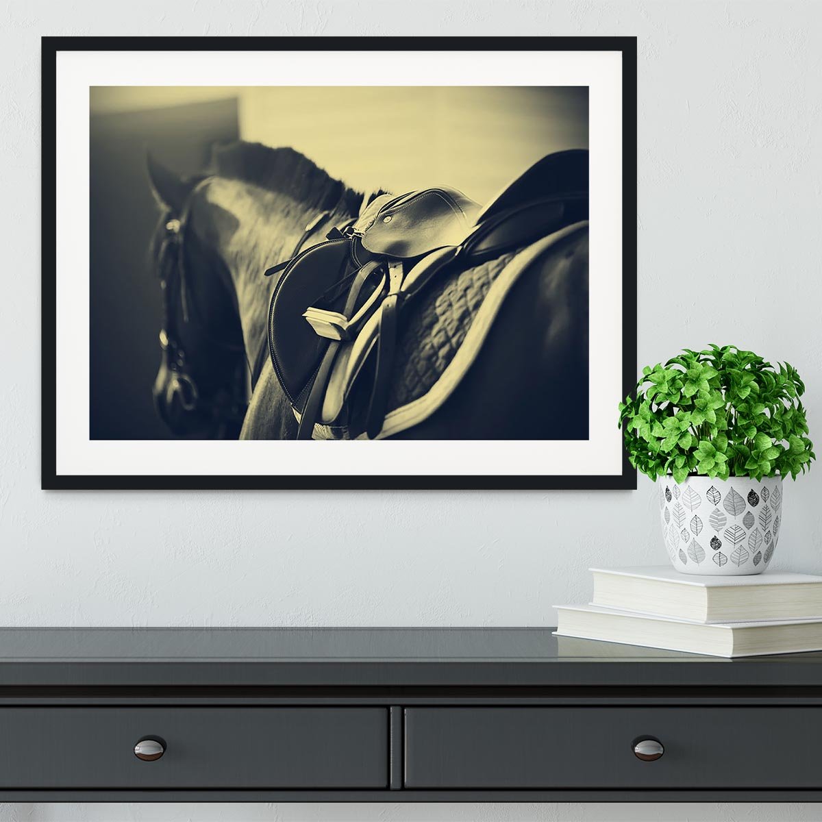 Saddle with stirrups on a back of a sport horse Framed Print - Canvas Art Rocks - 1