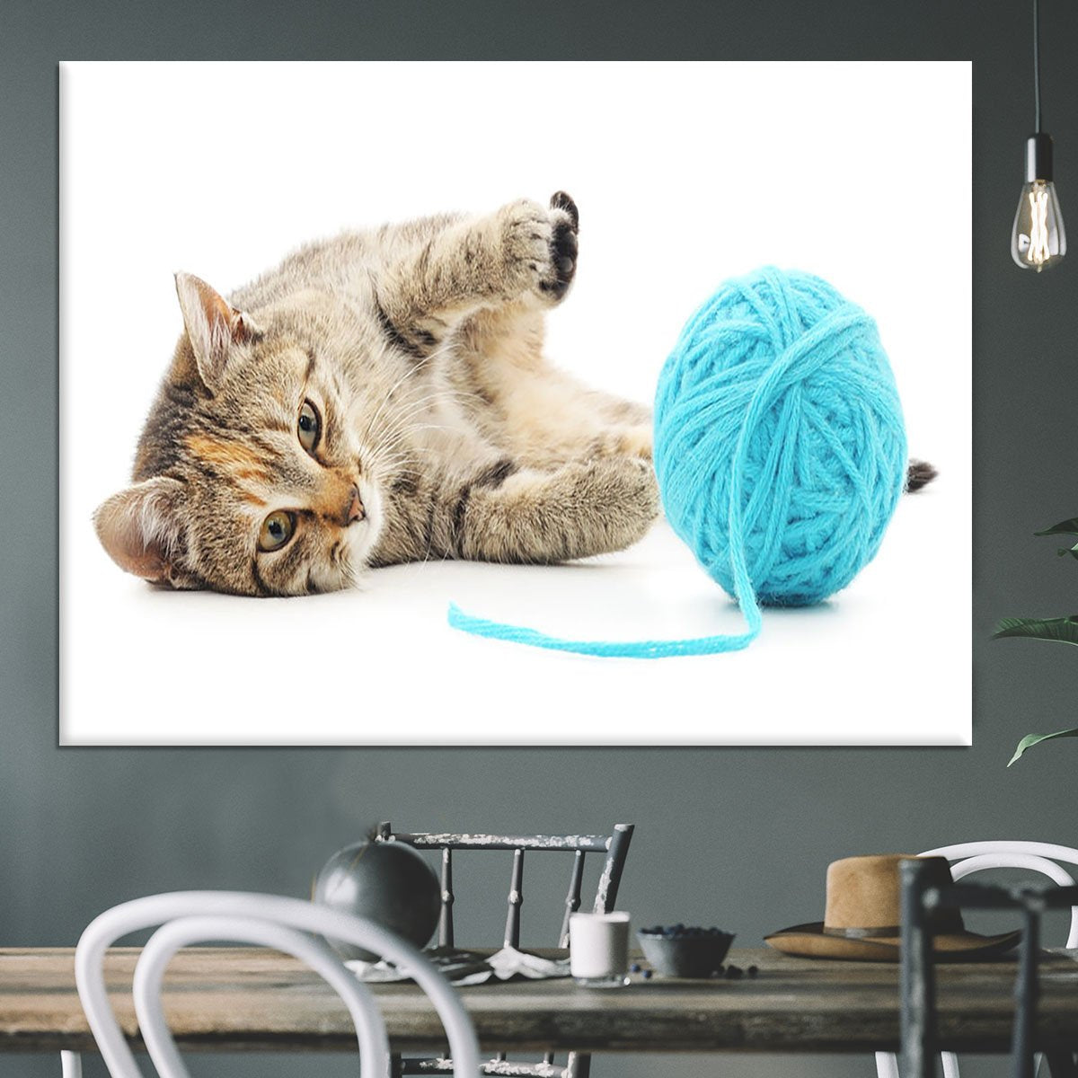 Small funny kitten and clew of thread Canvas Print or Poster