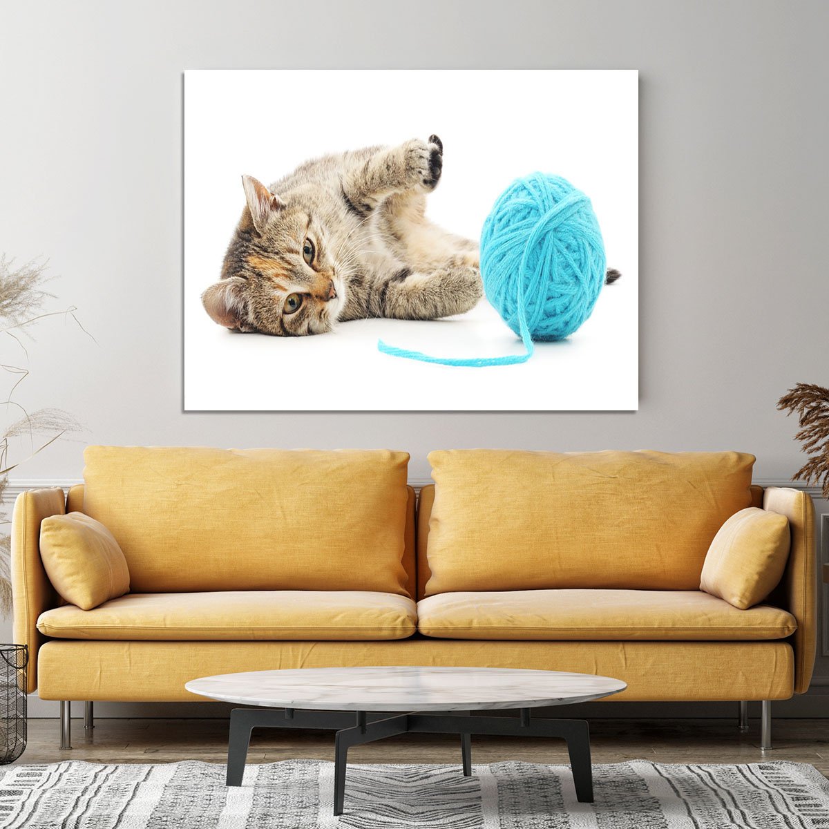 Small funny kitten and clew of thread Canvas Print or Poster