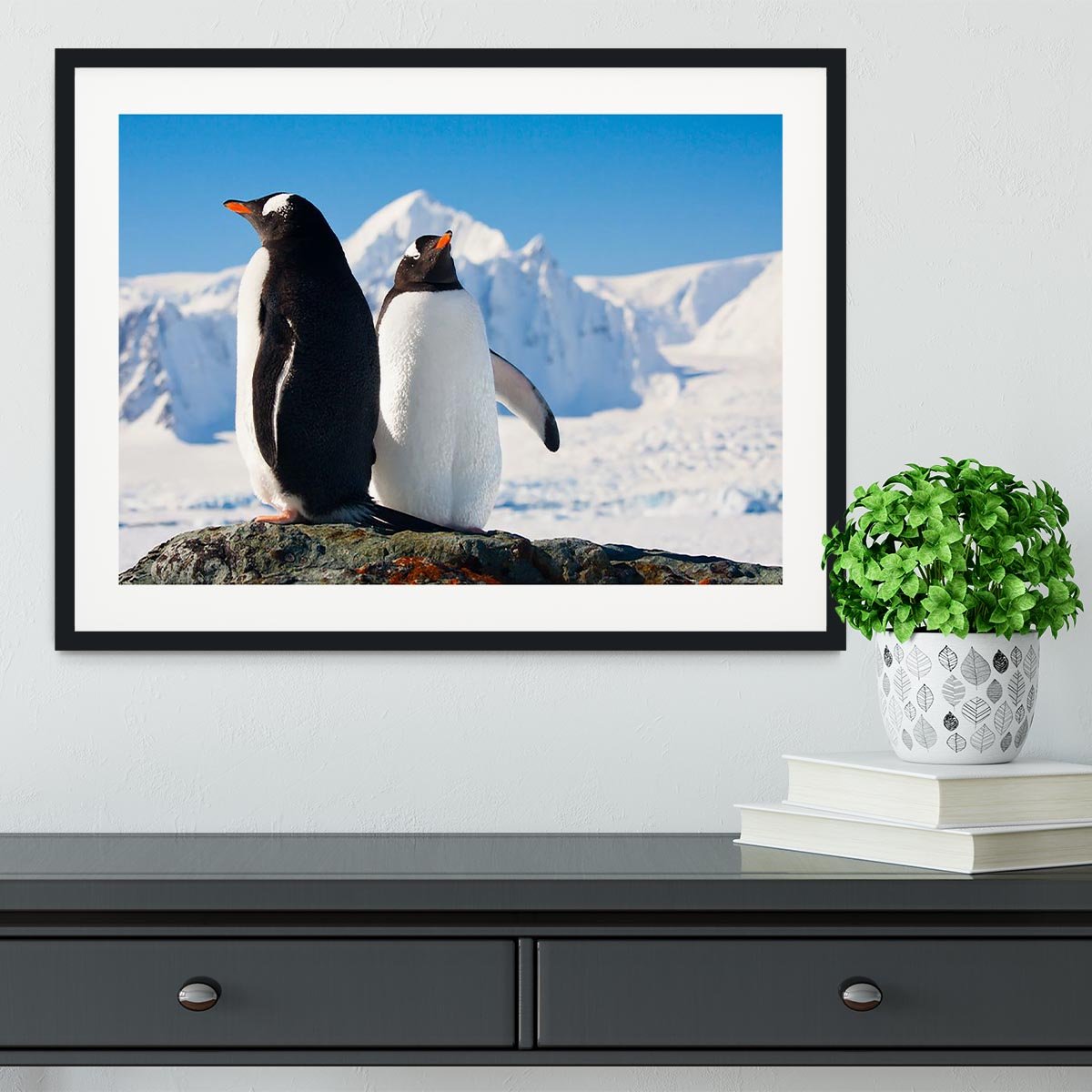 Two penguins dreaming together sitting on a rock Framed Print - Canvas Art Rocks - 1