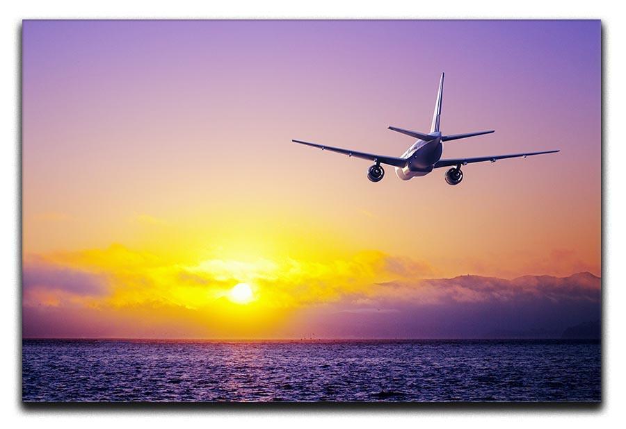 airplane in the sky over ocean Canvas Print or Poster  - Canvas Art Rocks - 1